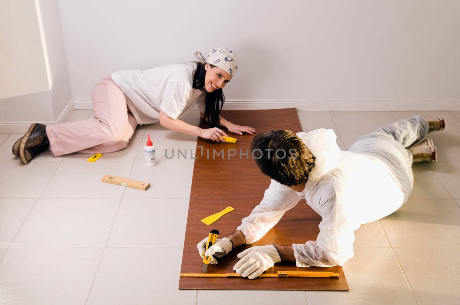 High angle view of a couple marking on a wood panel