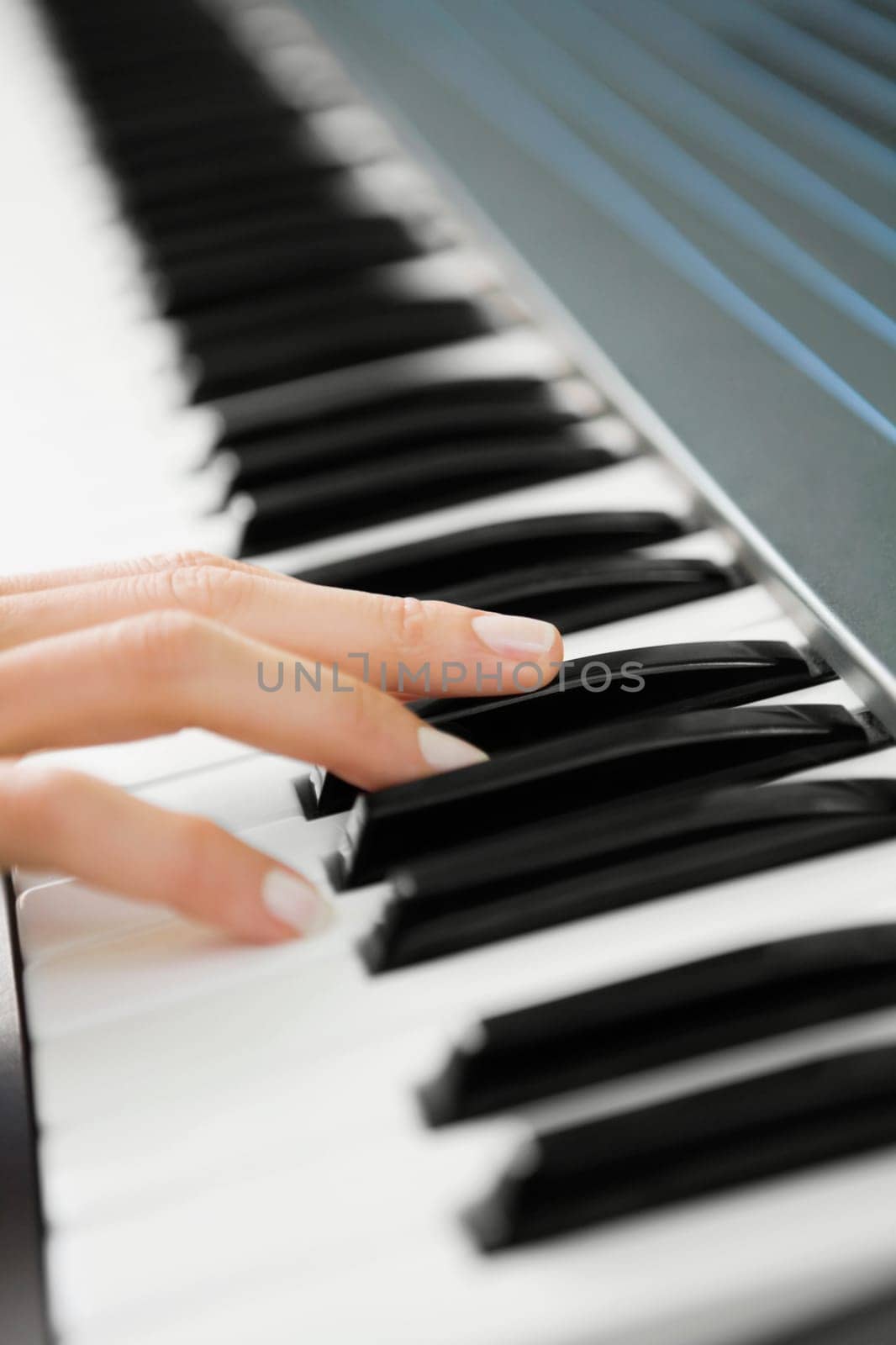 Close_up of a personŽs hand playing a piano
