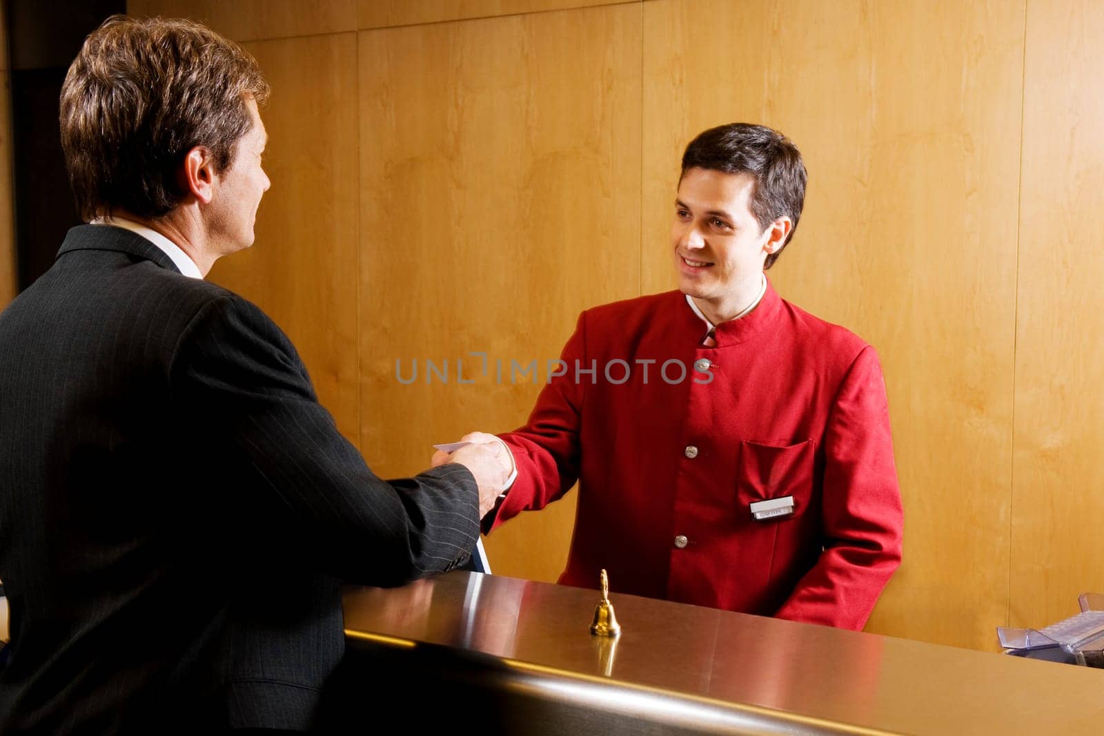 Waiter giving cardkey to a businessman