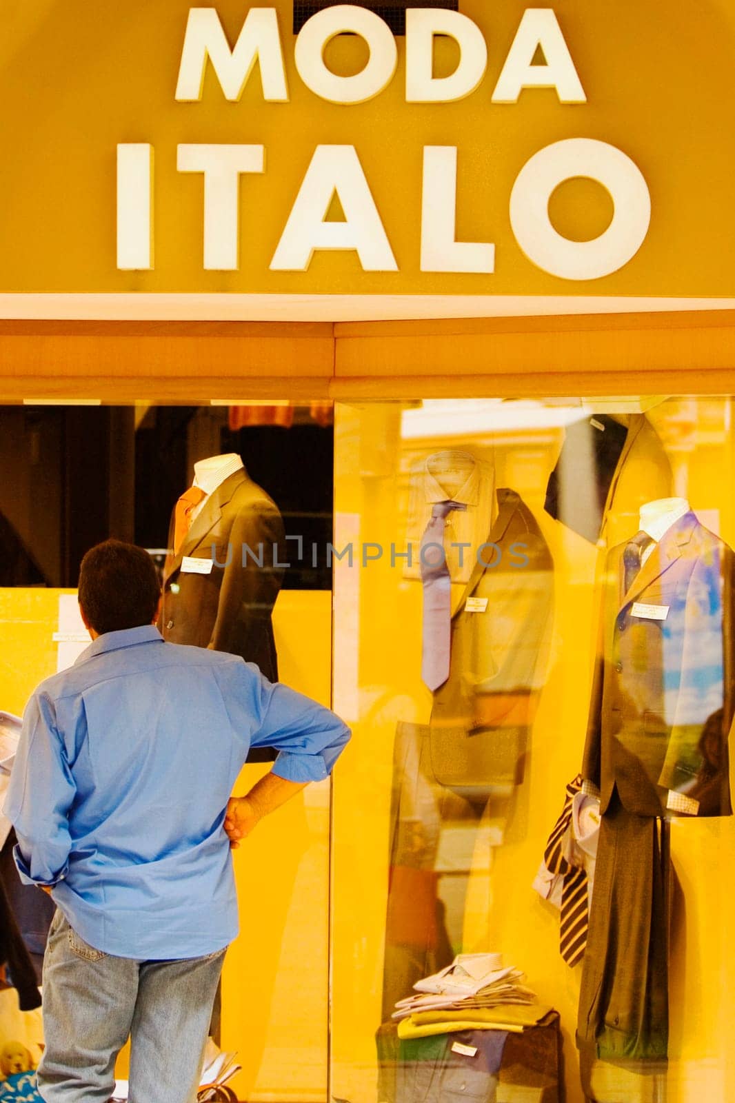 Man looking at the window display at a clothing store, Genoa, Liguria, Italy