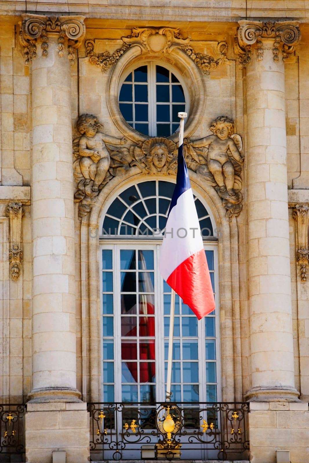 French flag in front of a government building, Place de la Bourse, Bordeaux, France