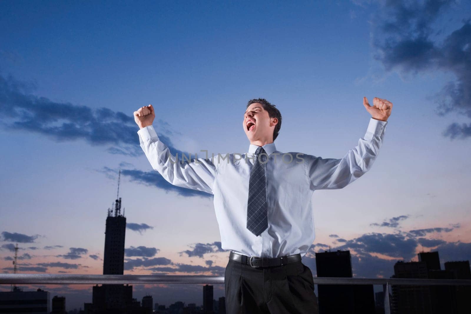 Businessman shouting with his arms outstretched