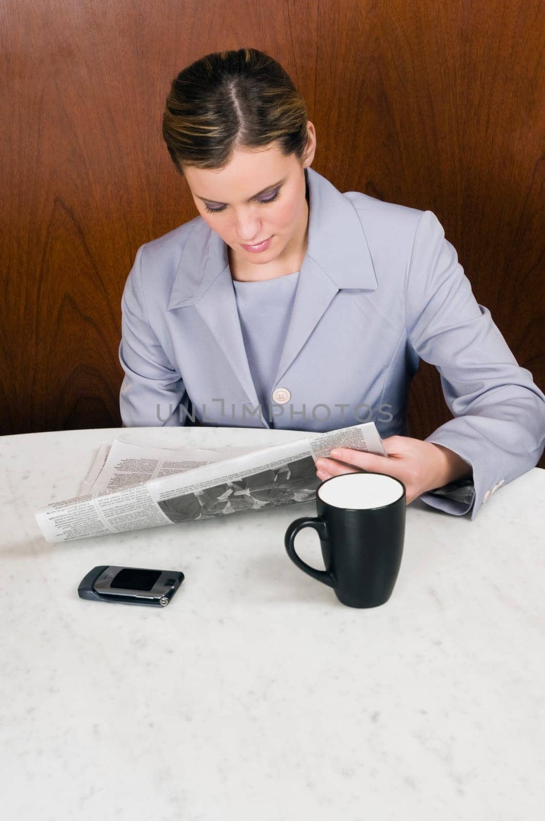 High angle view of a businesswoman reading newspaper in a cafe