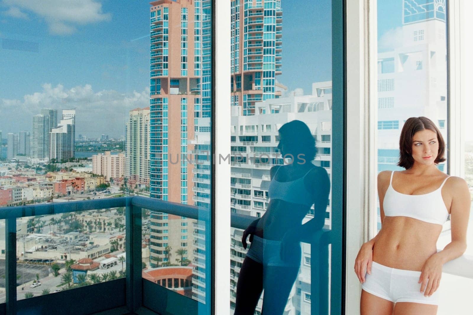 Young woman leaning against a railing in a balcony