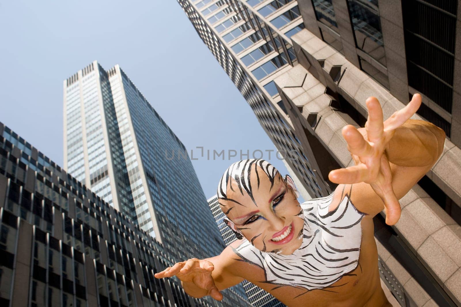 Low angle view of a young man imitating to be a tiger, New York City, New York State, USA