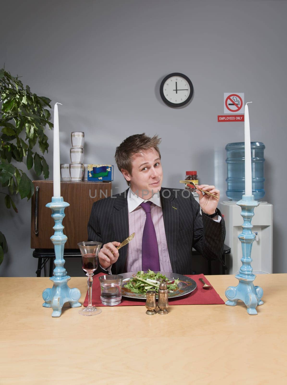 Portrait of a businessman having lunch in the office
