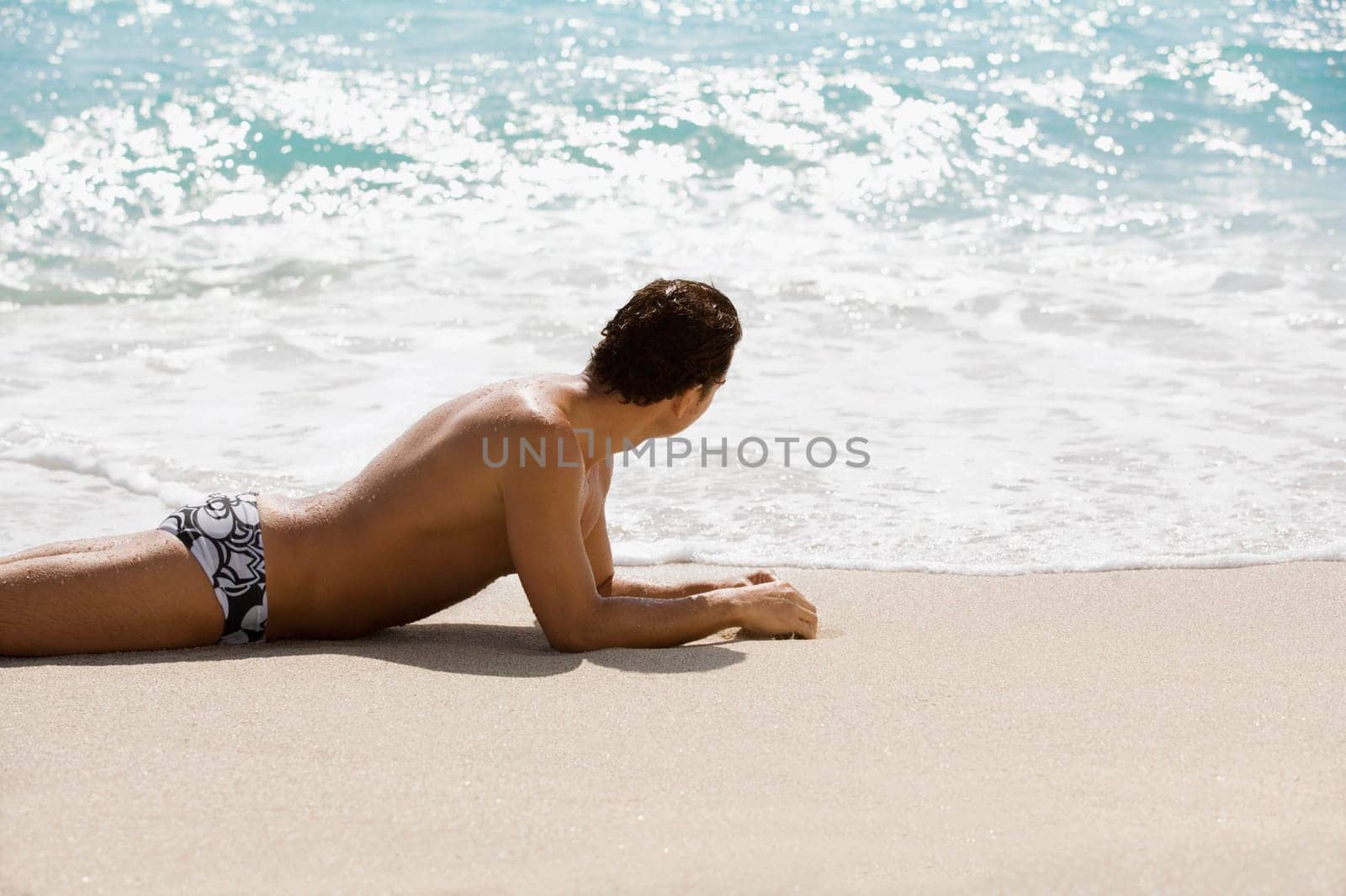Man sunbathing on the beach