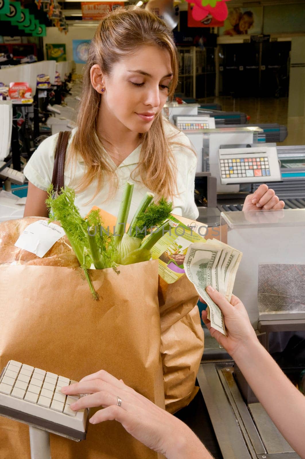 Sales clerk taking money from customer at checkout counter