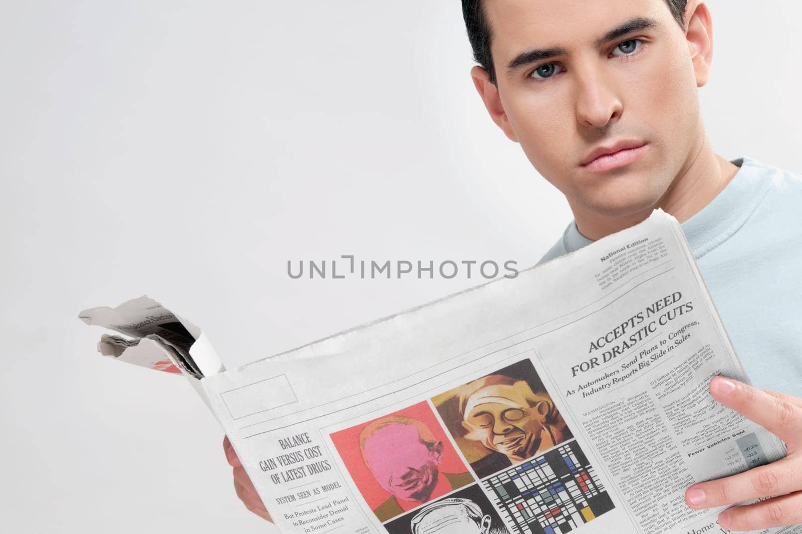 Close_up of a man reading a newspaper