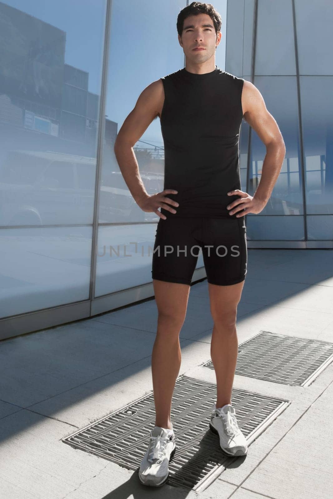 Man standing with arms akimbo