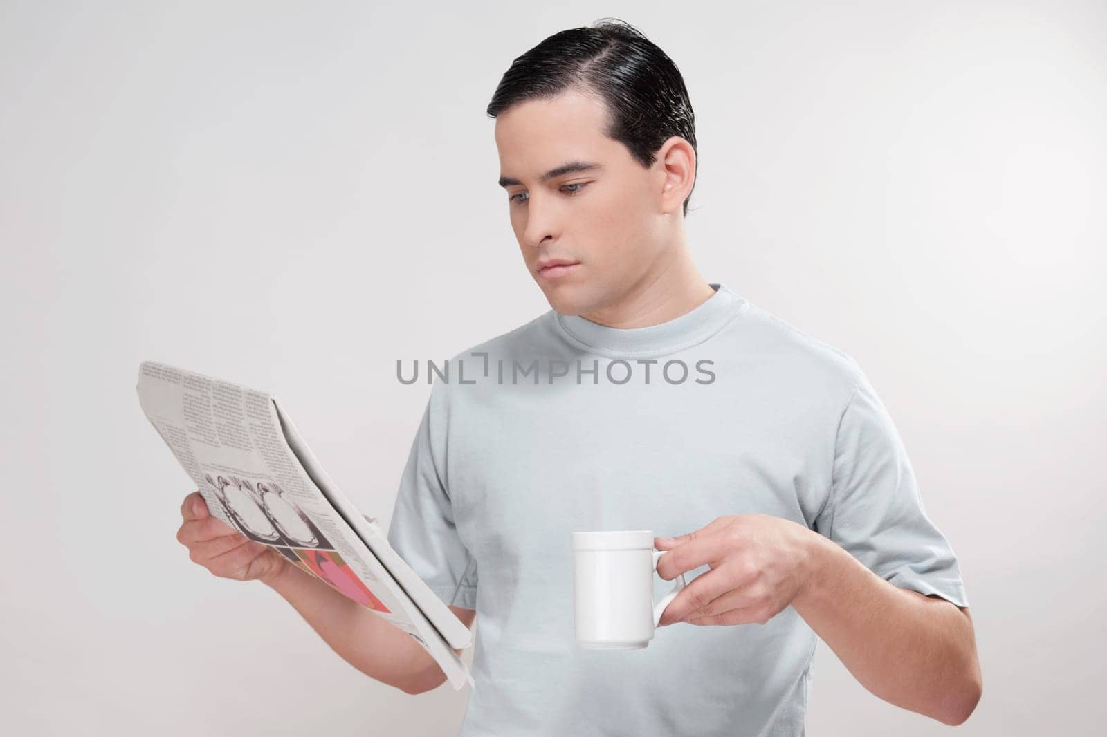Close_up of a man reading a newspaper