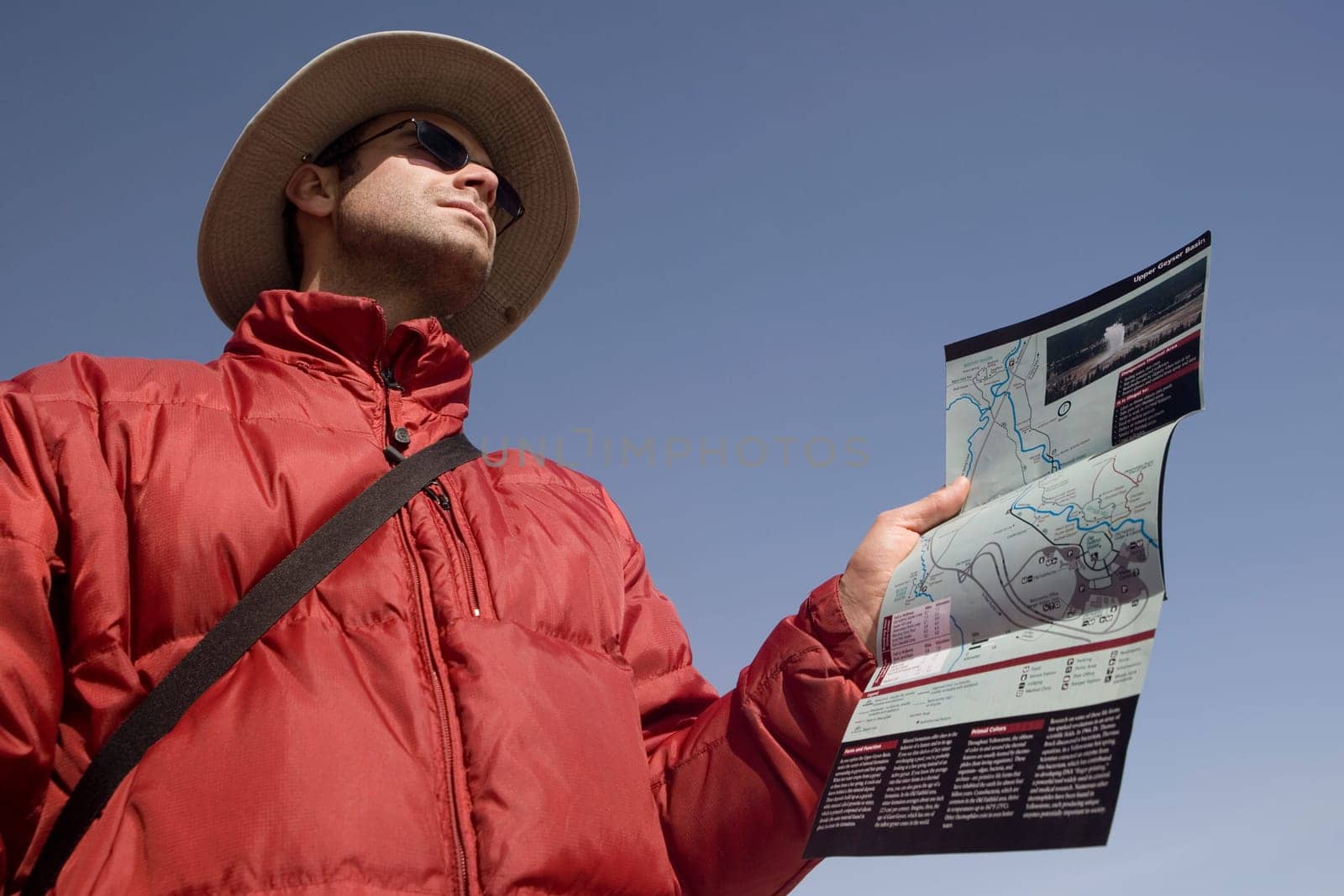 Low angle view of a mid adult man holding a map