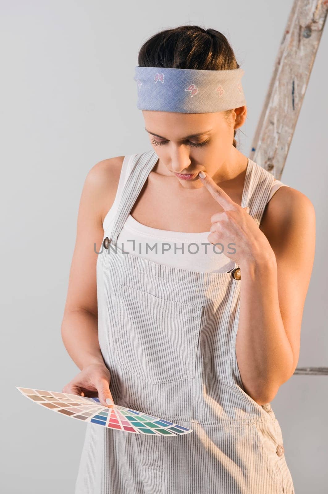 Young woman choosing color from a color swatch