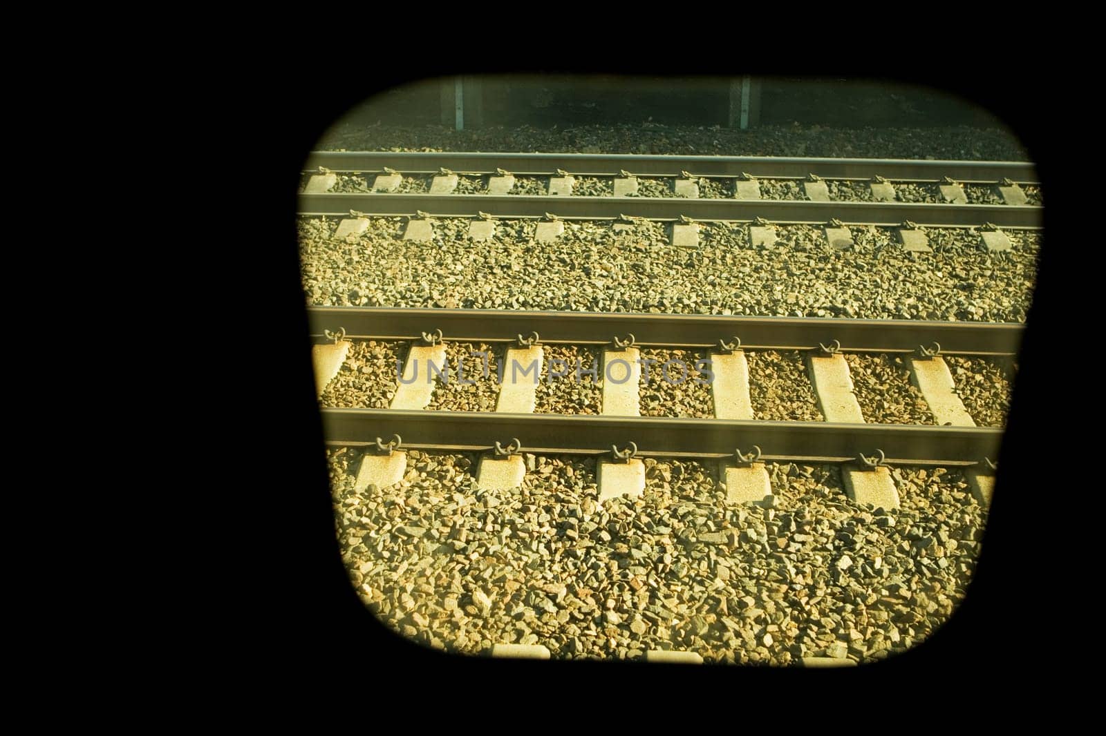 Railroad track viewed through a train window