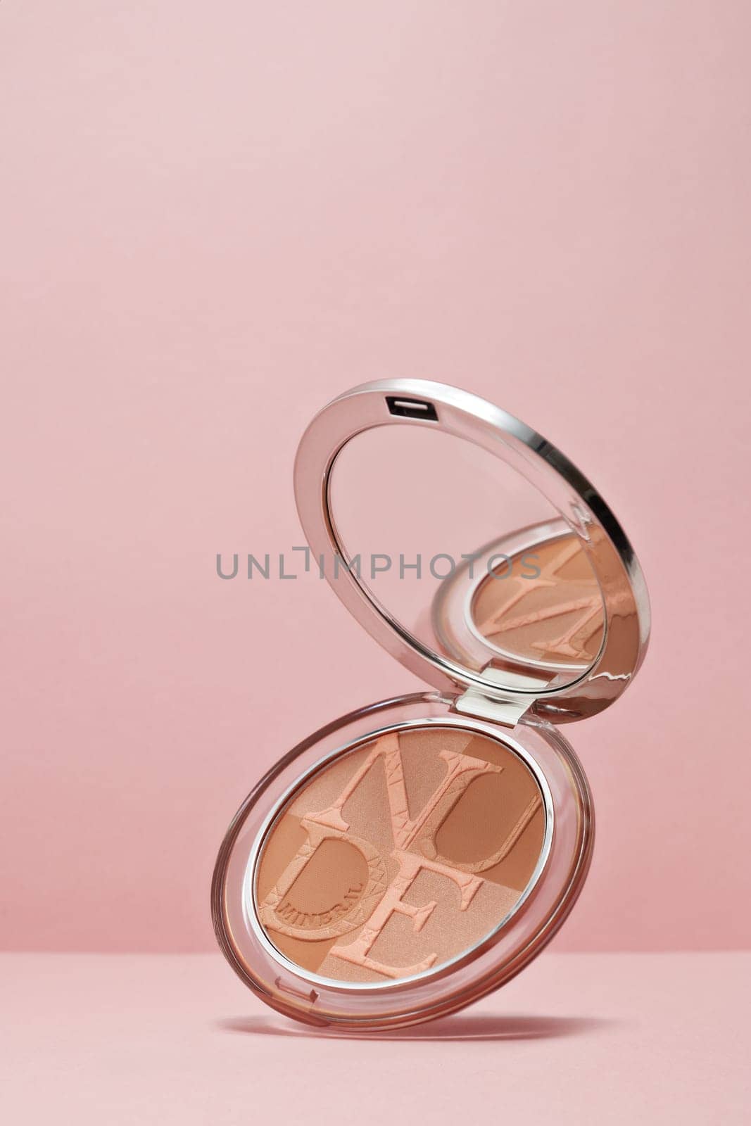 St.Petersburg, Russia - March 2020 - Palette of powder Diorskin mineral nude bronze on pink background. Product  from Christian Dior