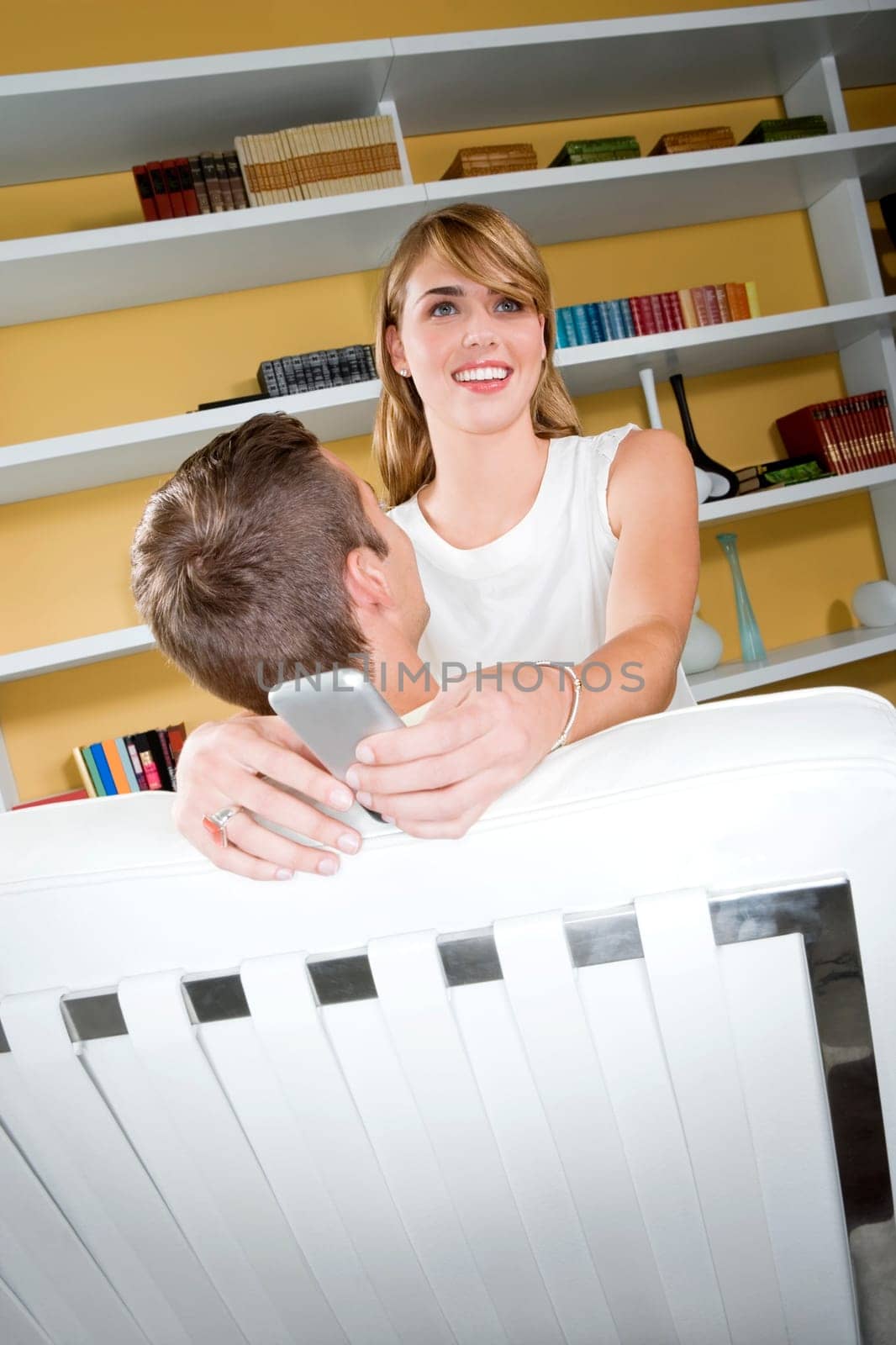 Young women embracing a young man and smiling