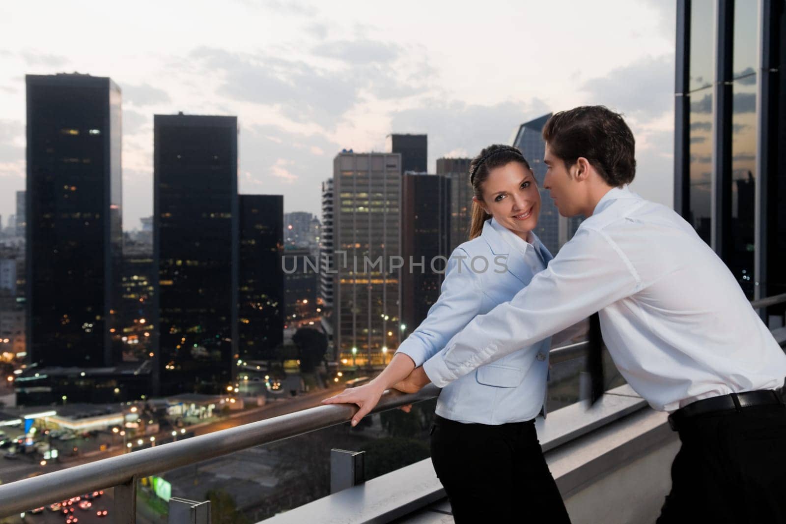 Side profile of a businesswoman and a businessman romancing