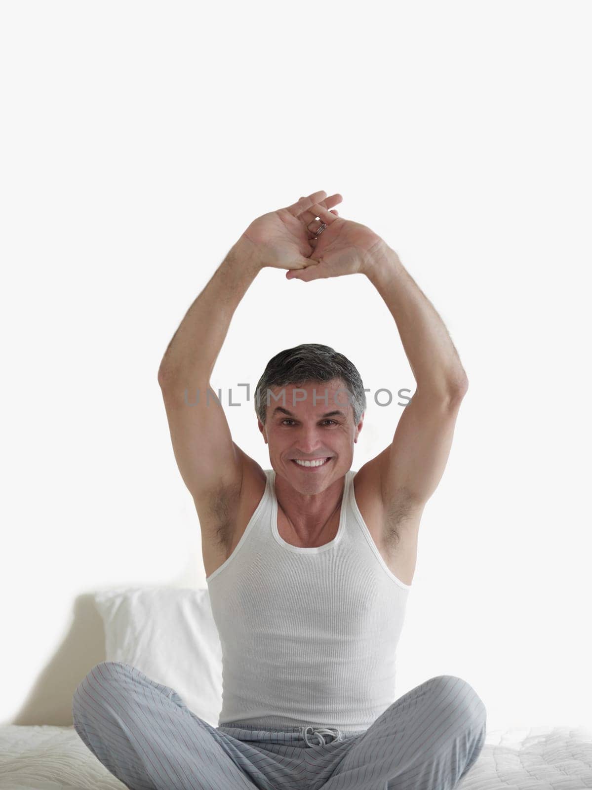 Portrait of a man stretching on the bed