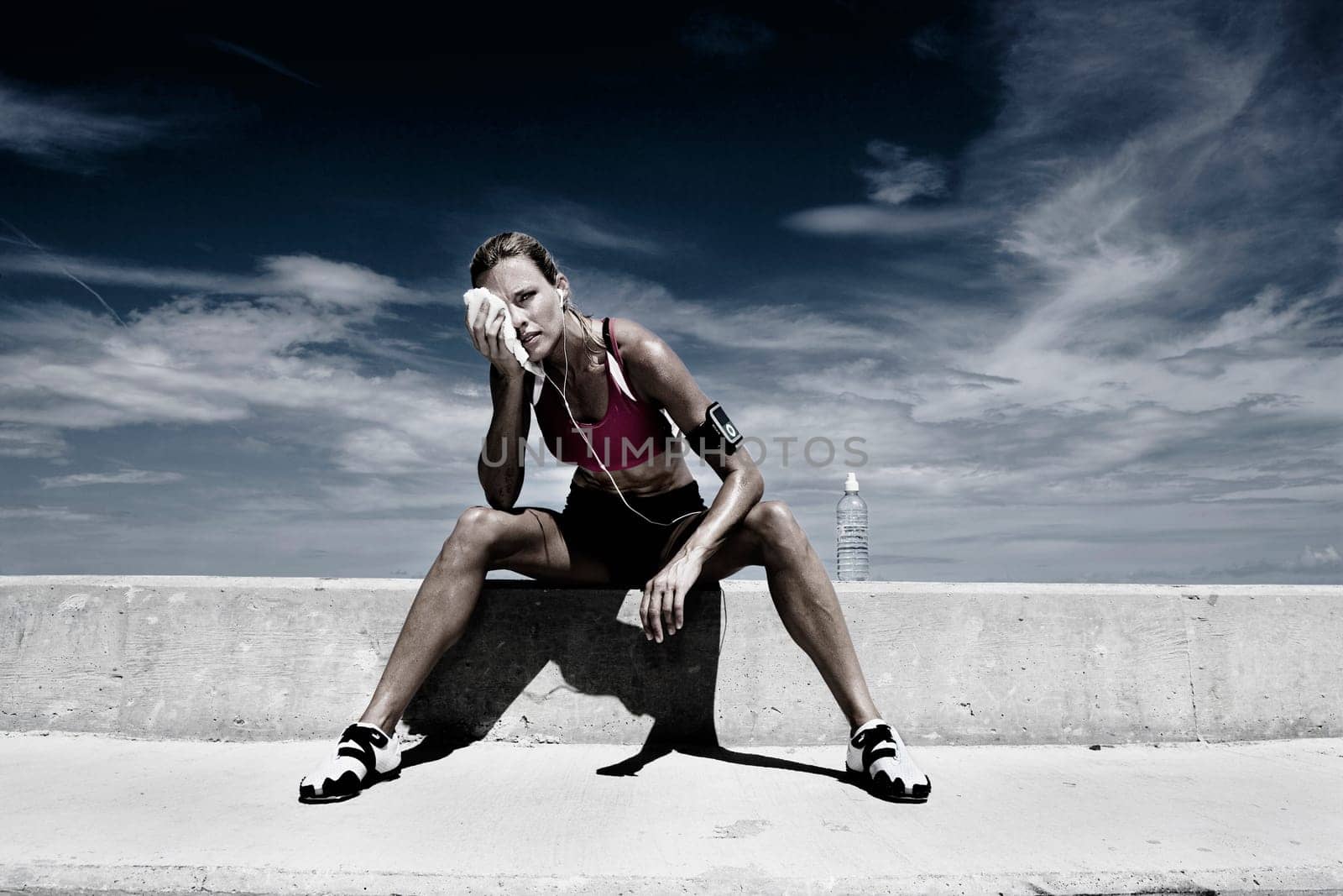 Mid adult woman sitting on a ledge