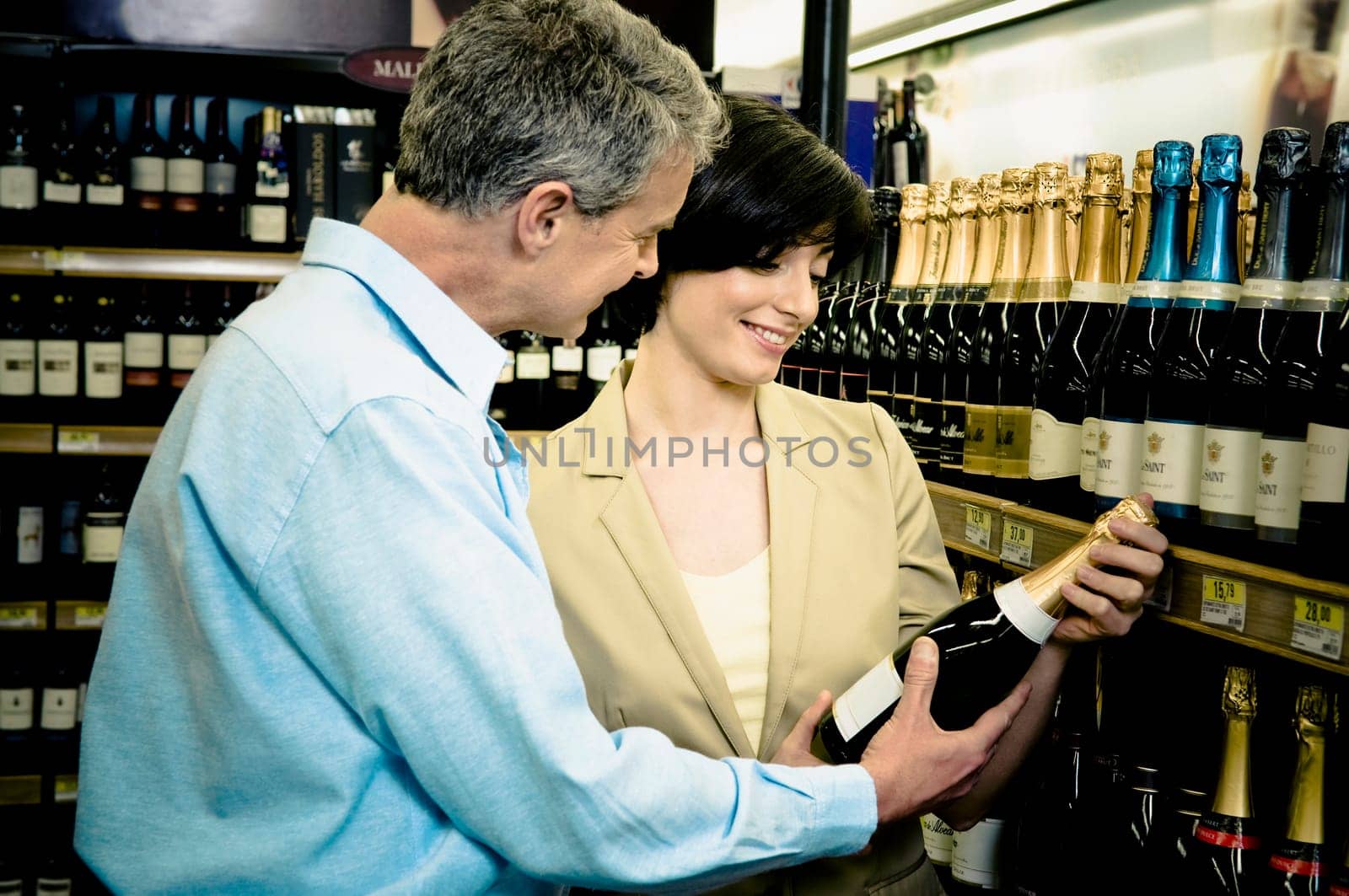 Couple buying a wine in a supermarket