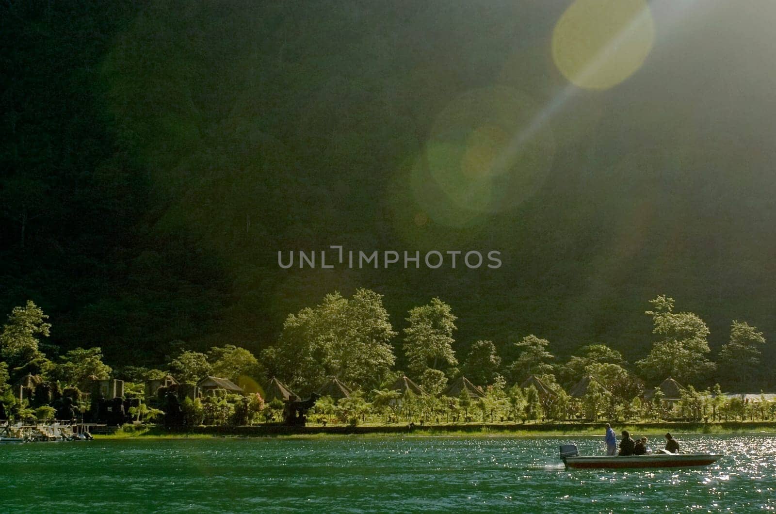 Tourists sitting on a boat in the sea, Tahiti, French Polynesia