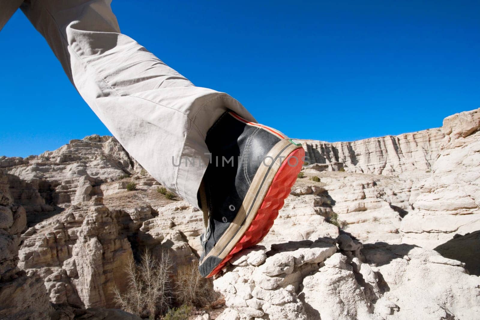 Low section view of a hiker walking on a rock
