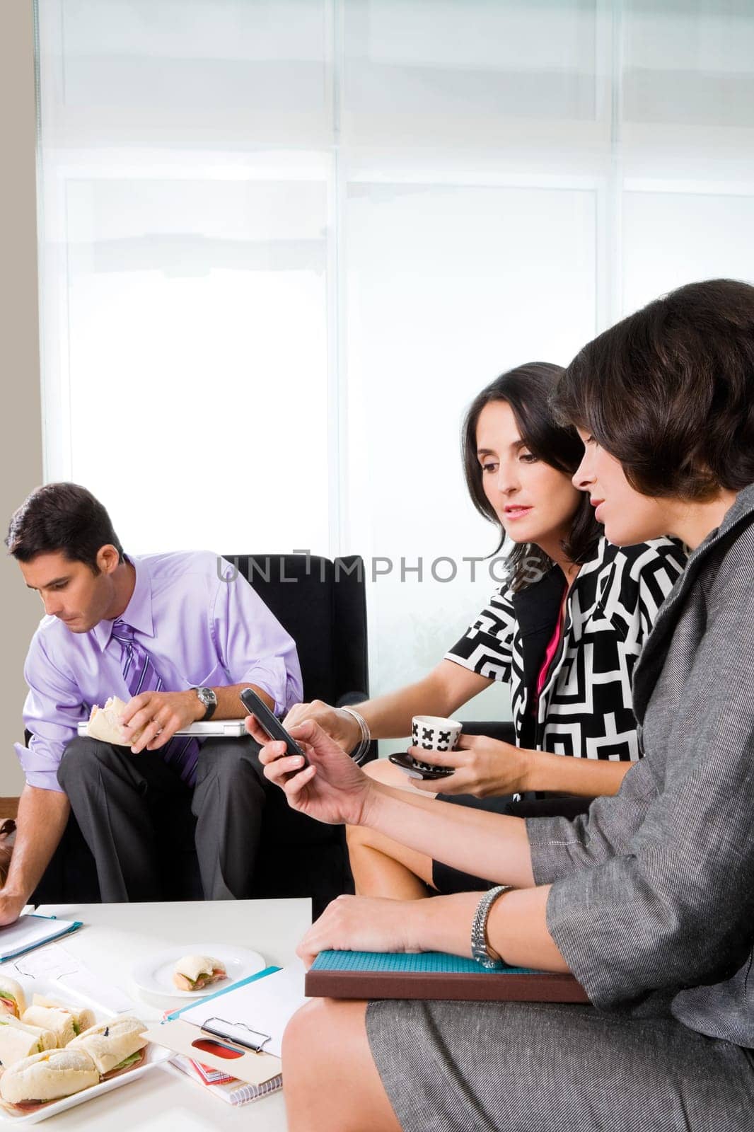 Two businesswomen looking at a mobile phone