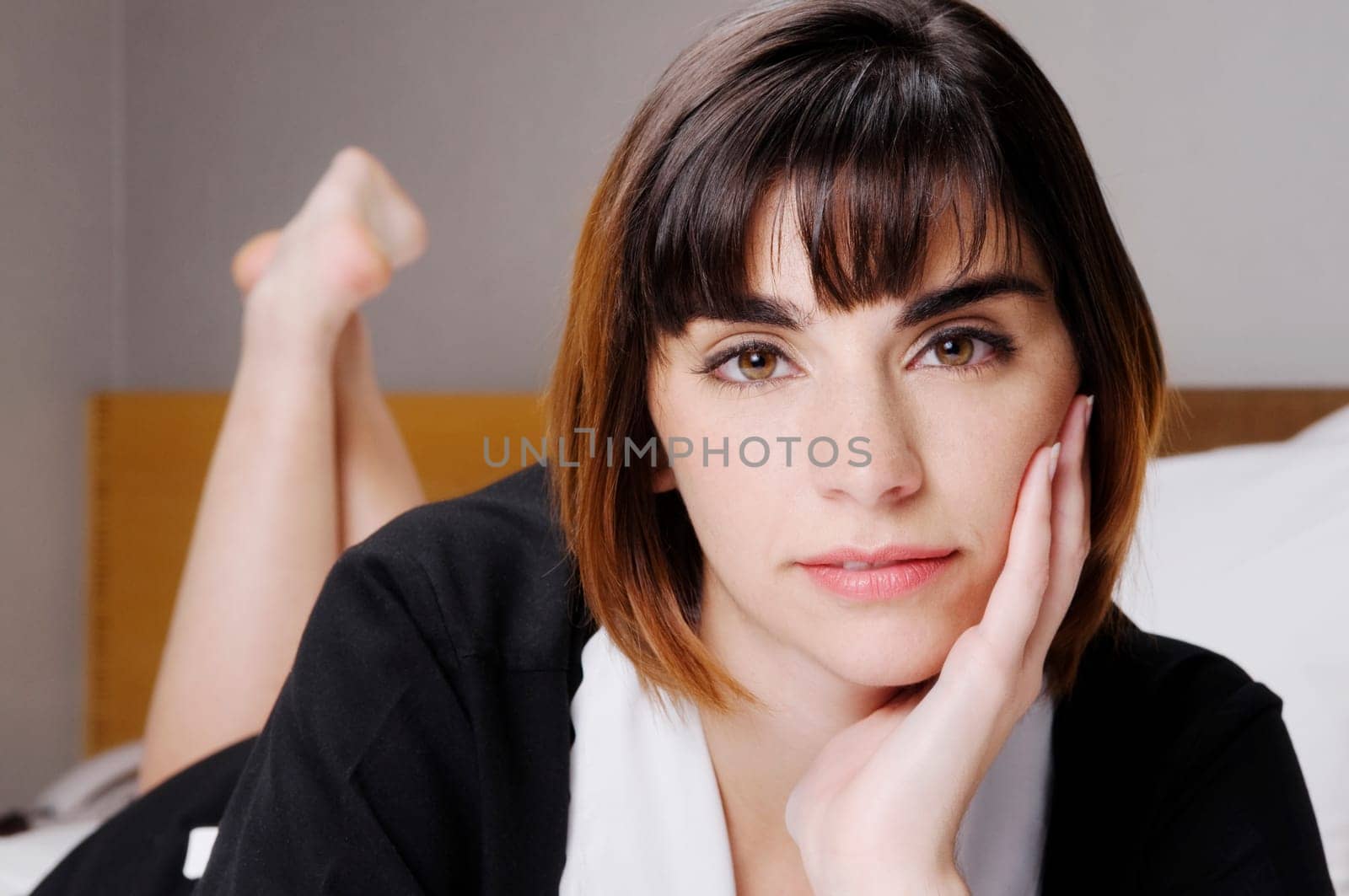 Portrait of a waitress lying on the bed