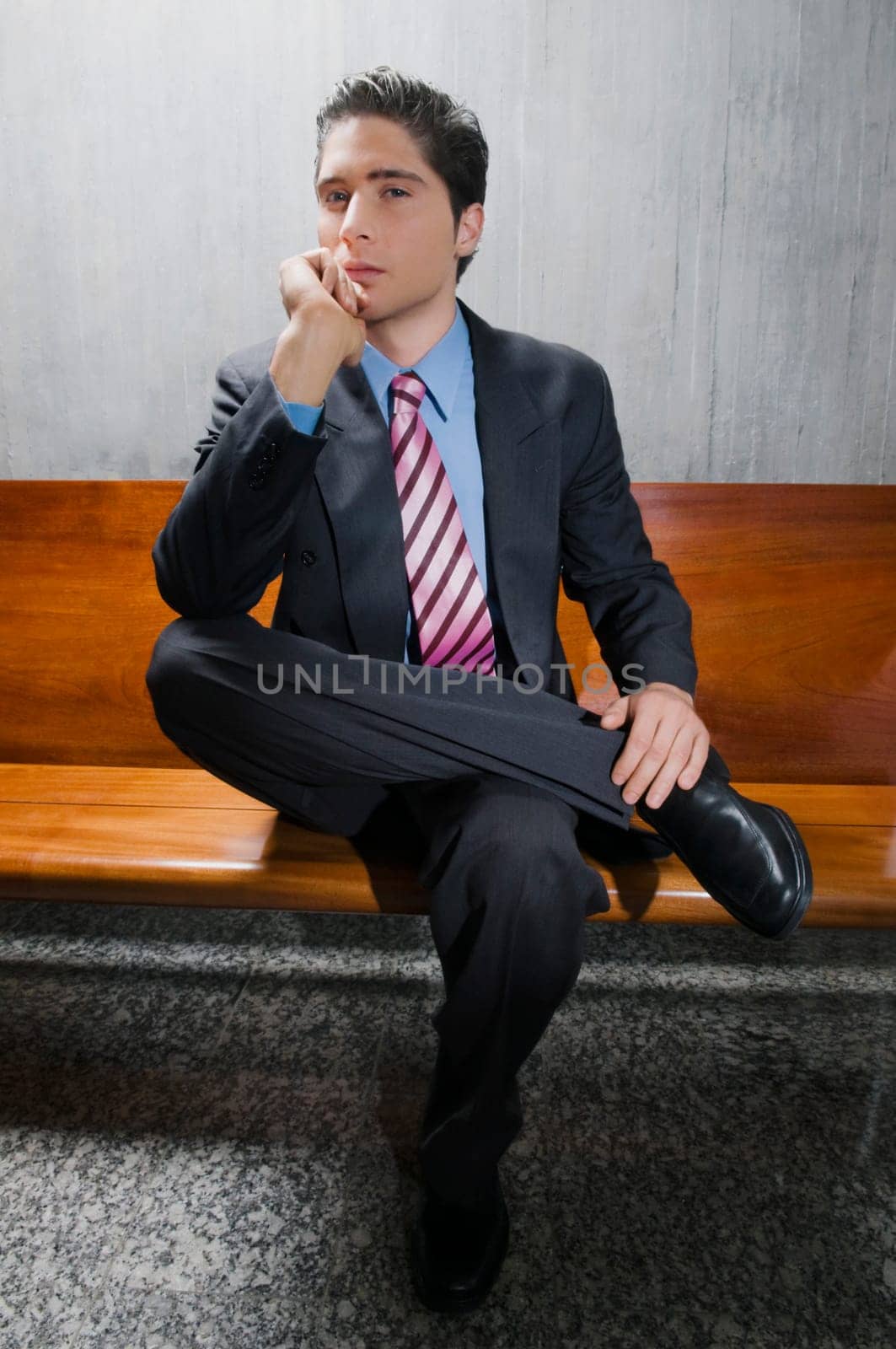 Portrait of a businessman sitting on a bench and thinking