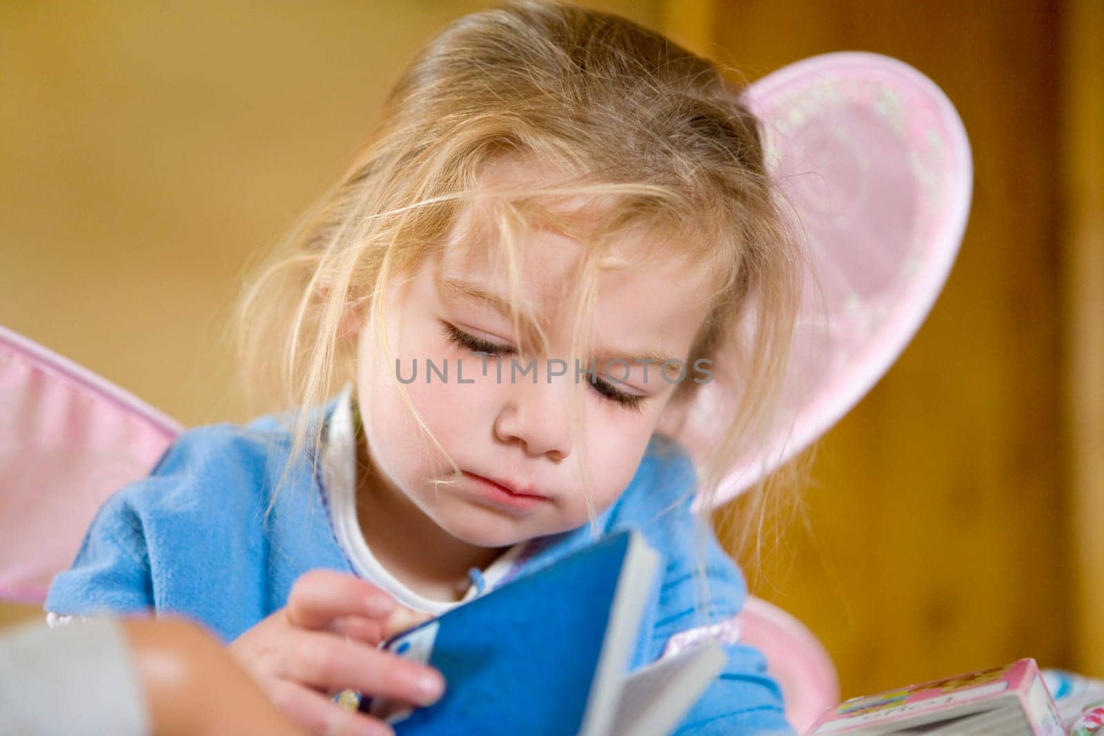Baby girl holding a book