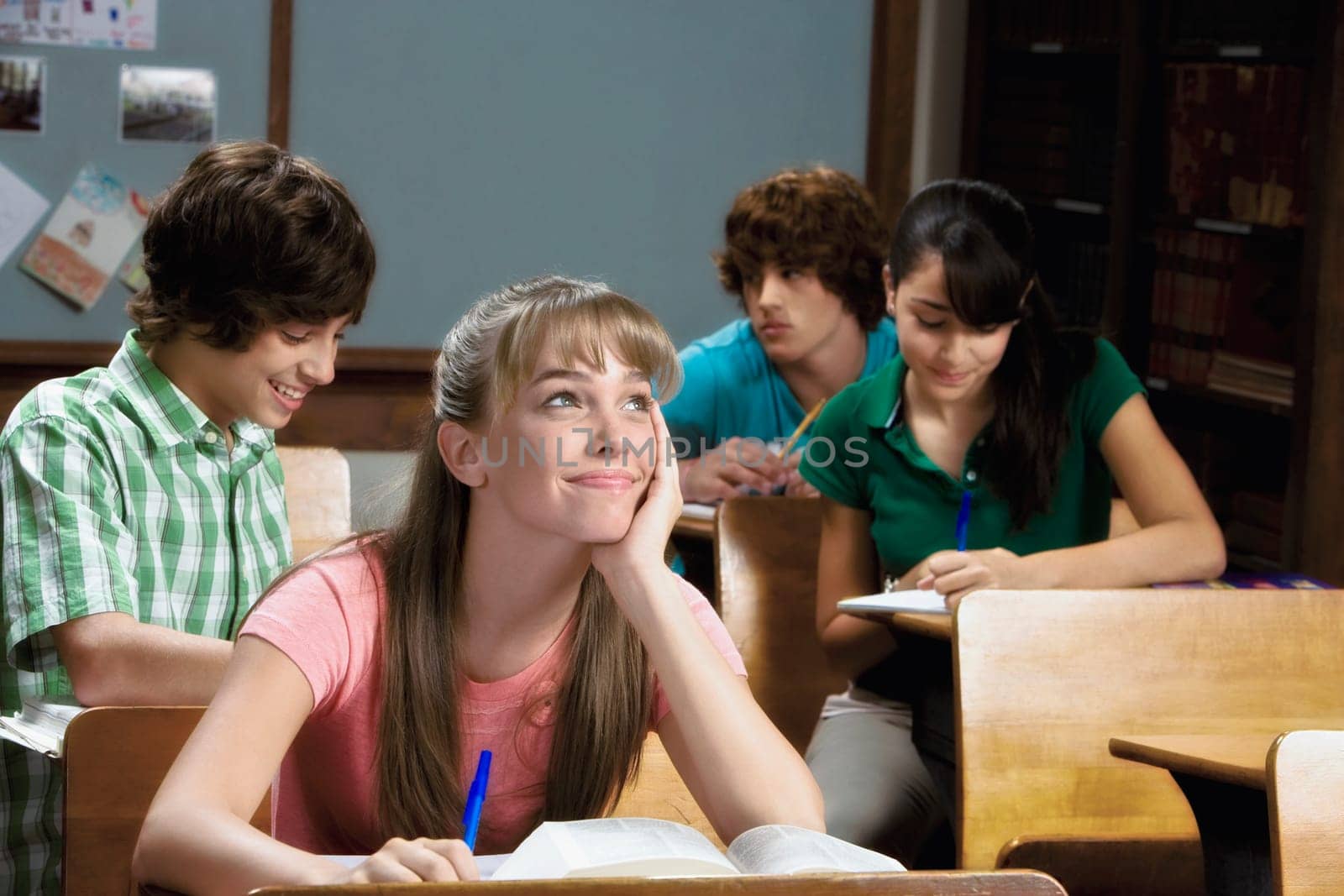 Student sitting in a classroom and day dreaming