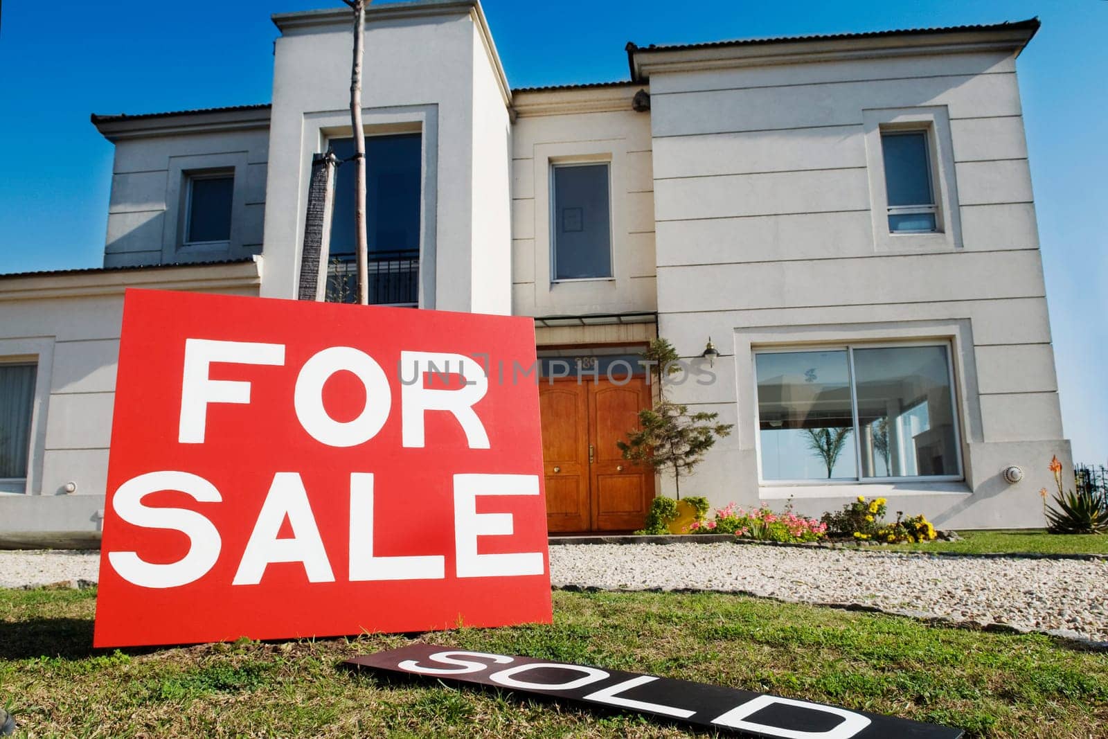 For sale information board in front of a house