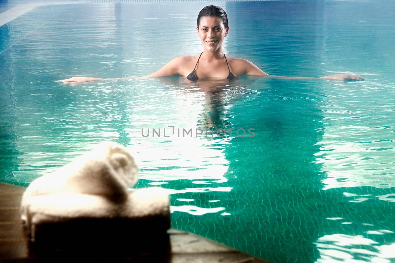 Young woman swimming in a swimming pool