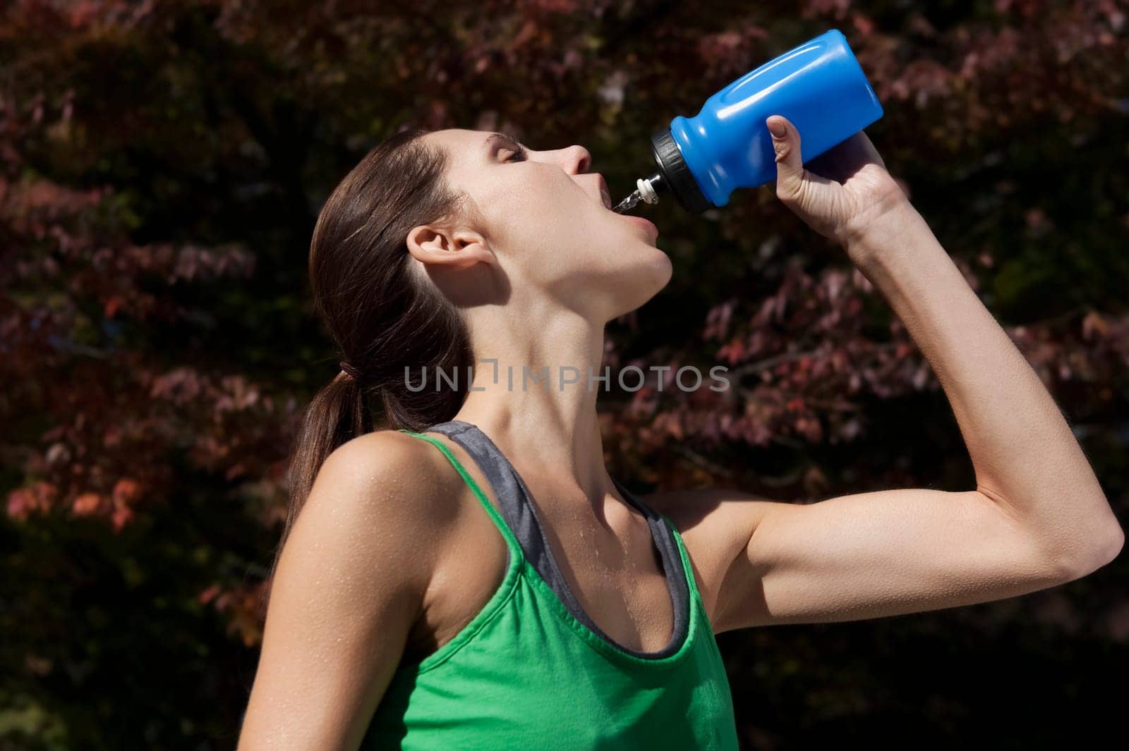 Woman drinking water after exercise