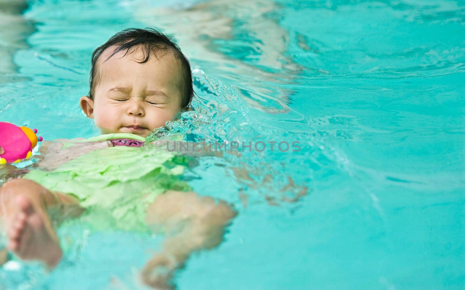 Baby girl in a swimming pool
