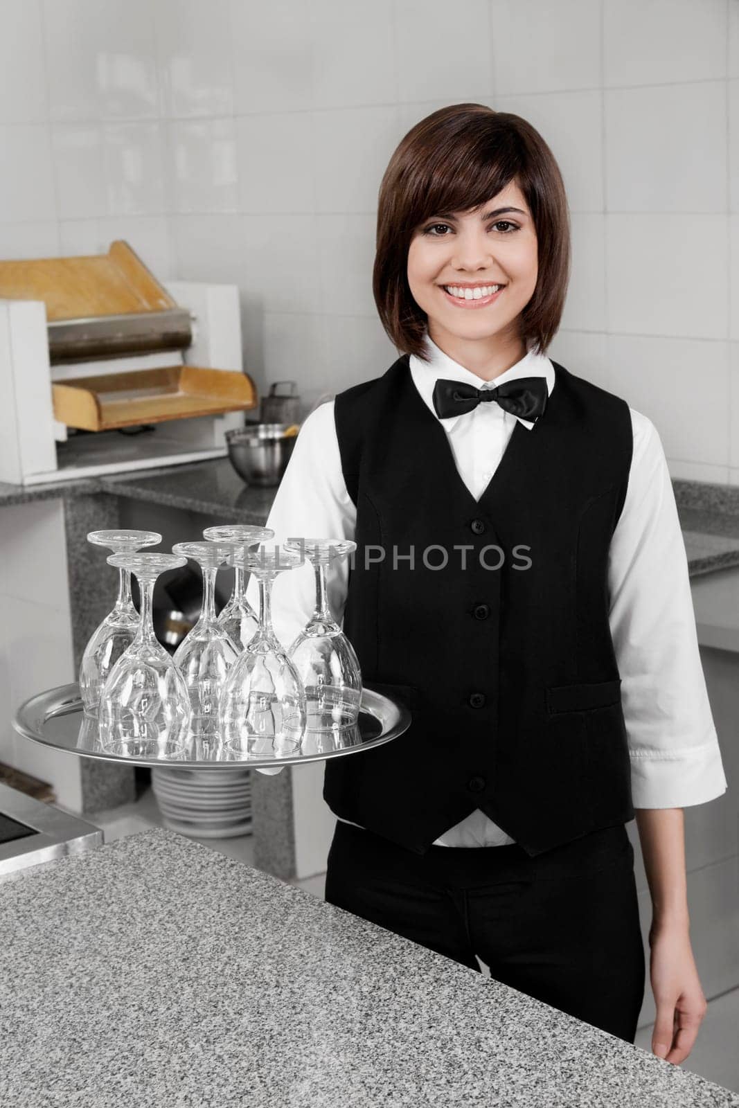 Portrait of waitress holding a tray of glasses