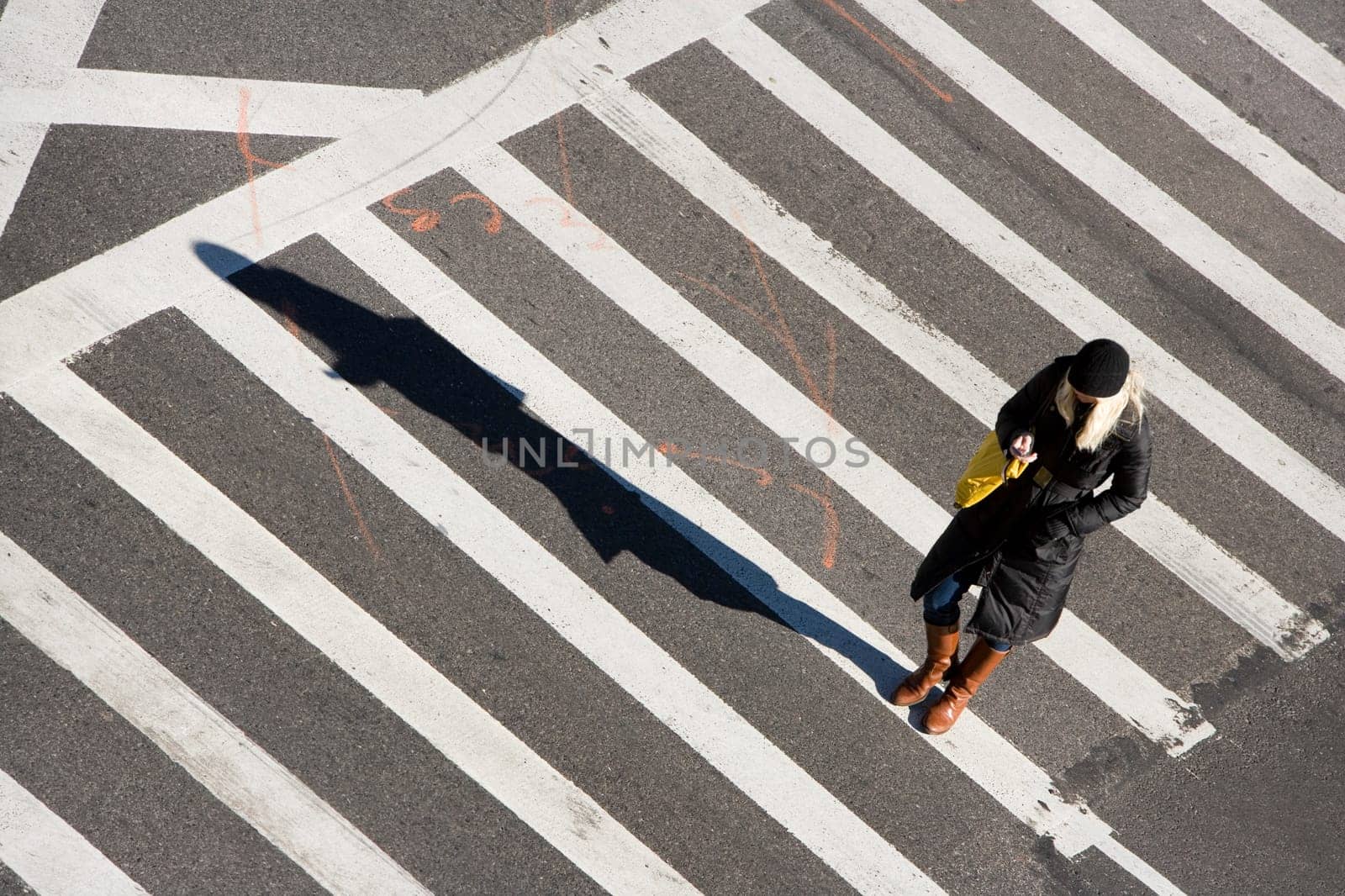 High angle view of a woman walking on the crosswalk, Ninth Avenue, New York City, New York state, USA