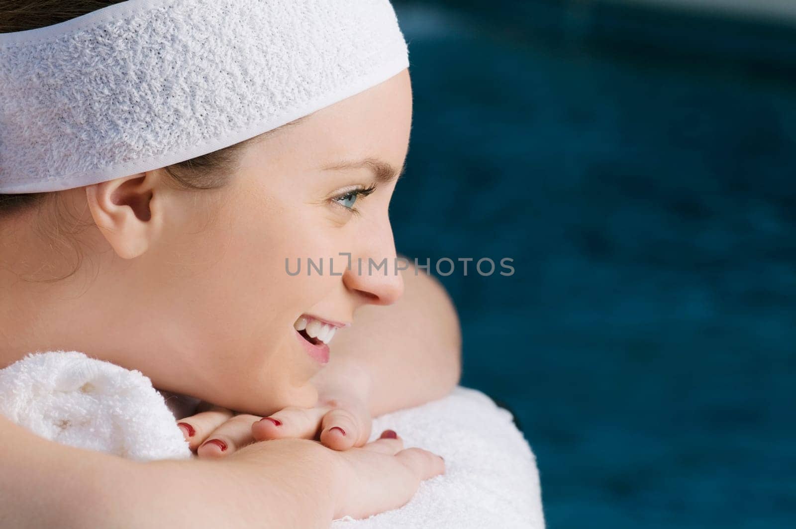Close_up of a young woman lying on a massage table and smiling