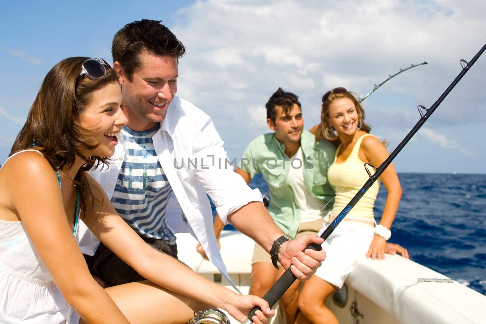 Two couples fishing in the sea
