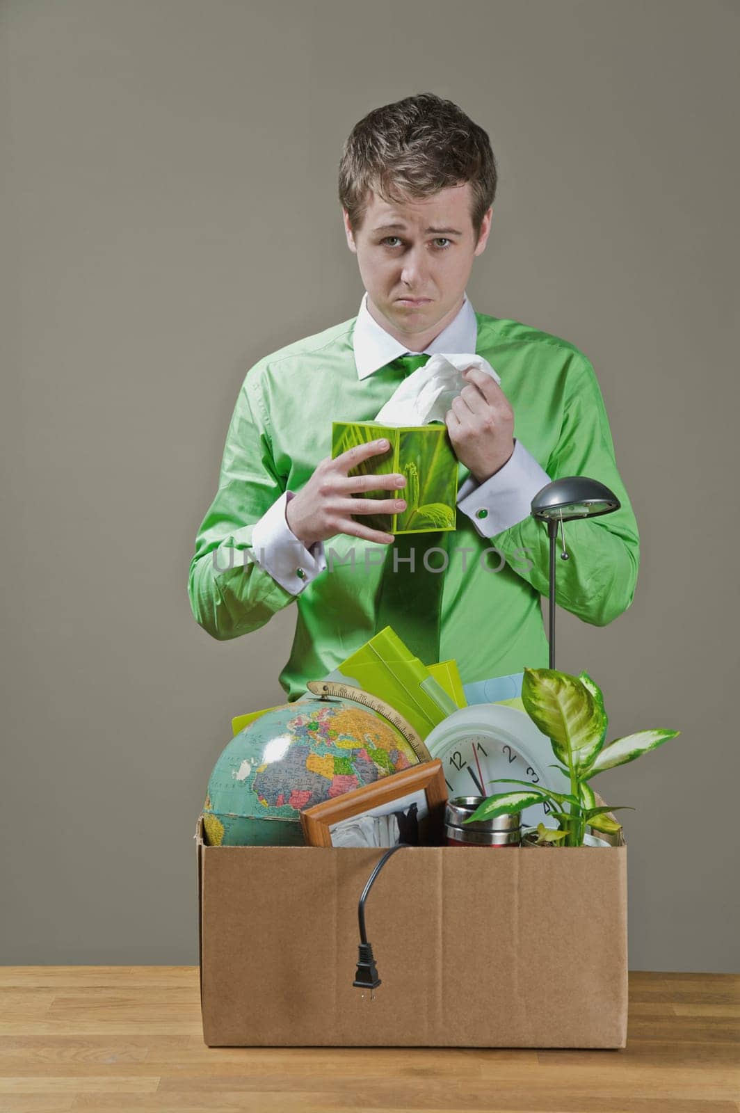 Fired businessman picking a tissue paper