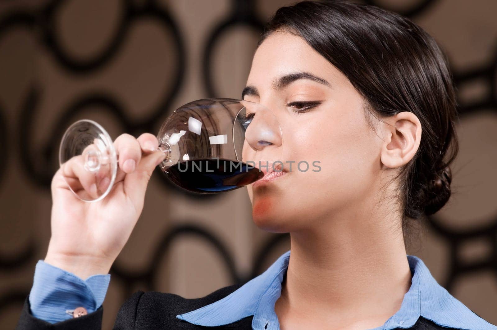 Businesswoman drinking wine