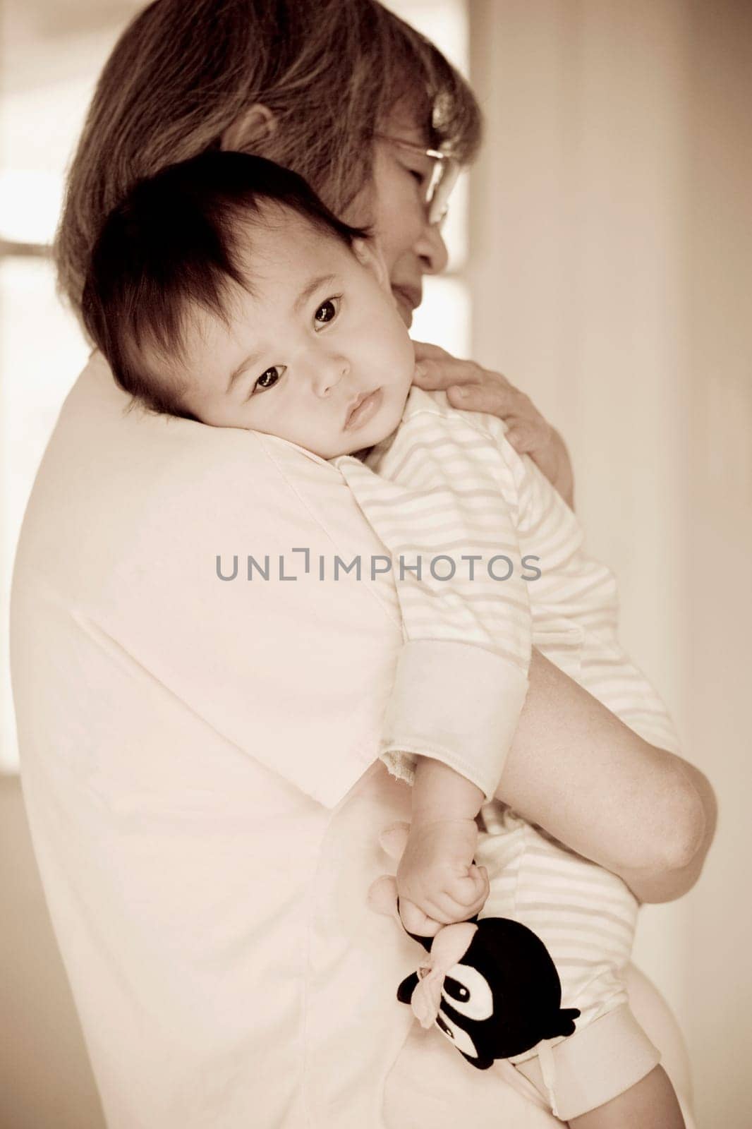 Close_up of a senior woman carrying her granddaughter