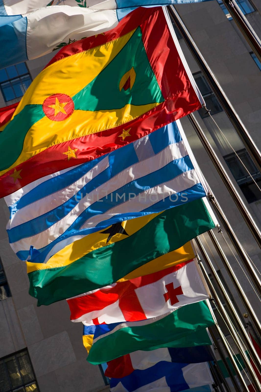 Low angle view of flags fluttering in a row, New York City, New York State, USA