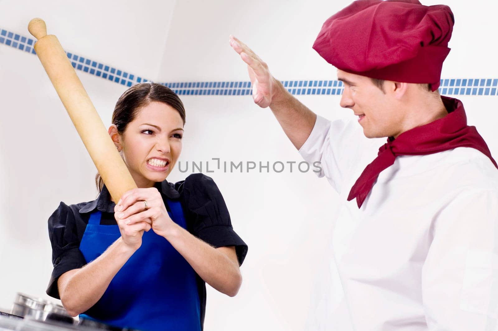 Female and a male chef fighting in the kitchen