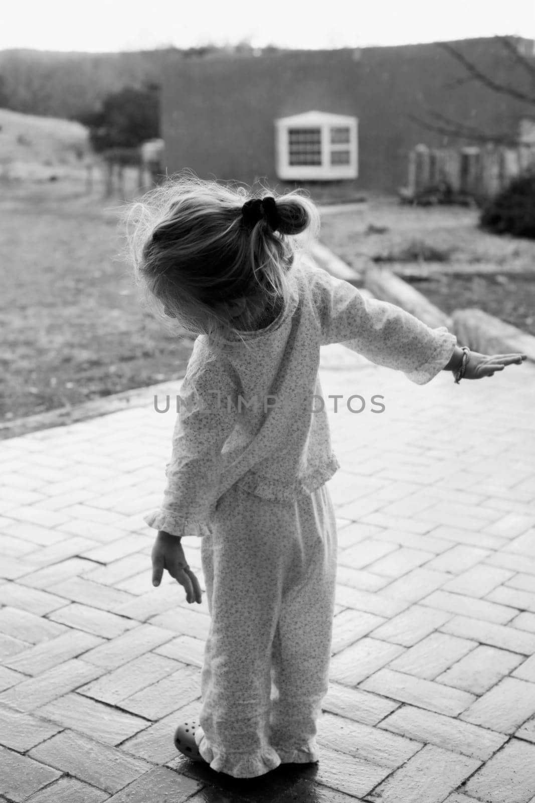 Rear view of a baby girl with her arms outstretched, Santa Fe, New Mexico, USA