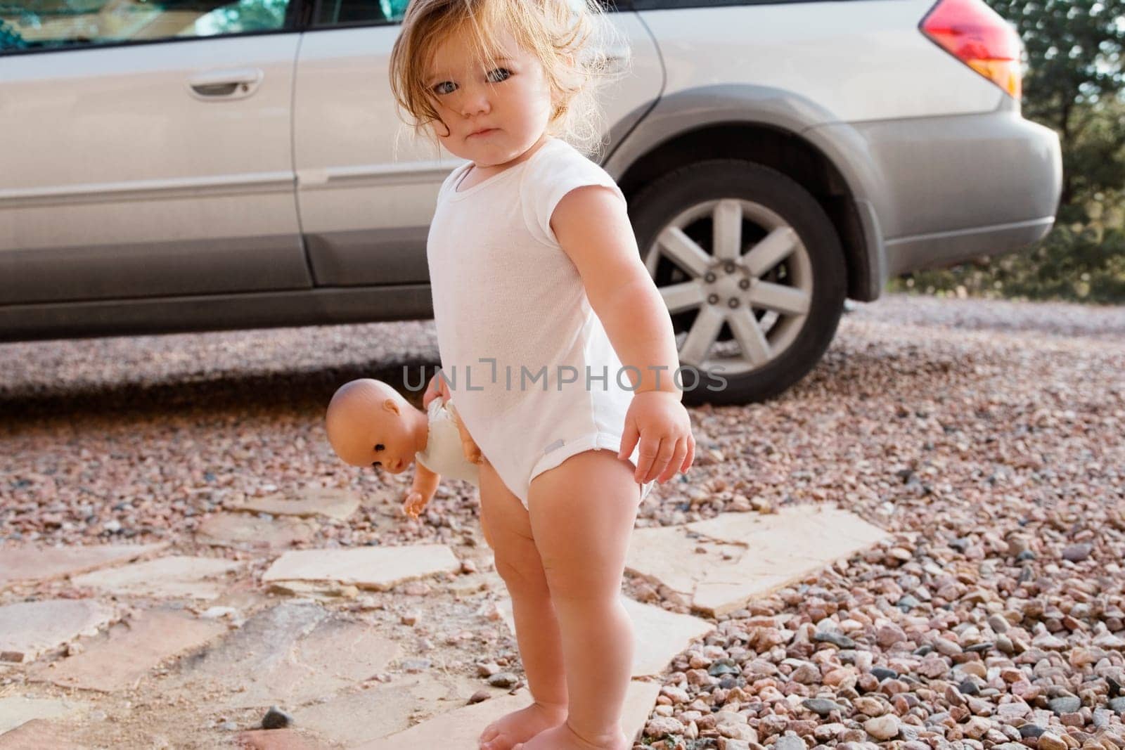 Portrait of a baby girl holding a doll