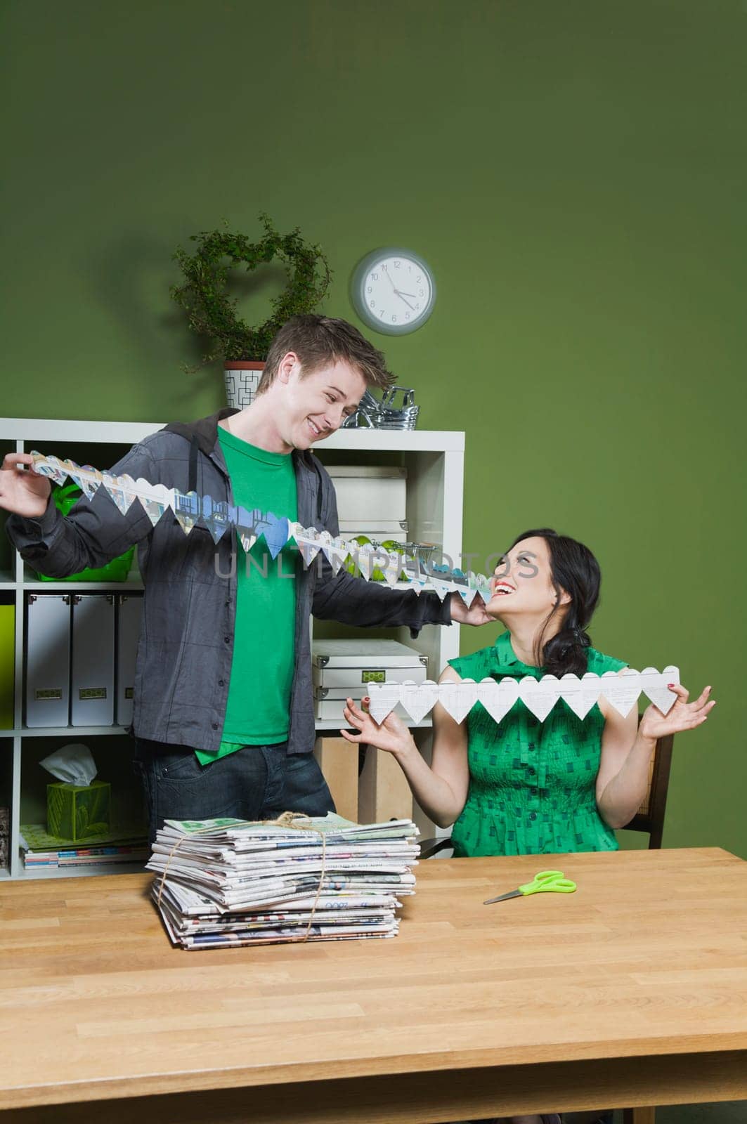 Man and a woman holding paper chains
