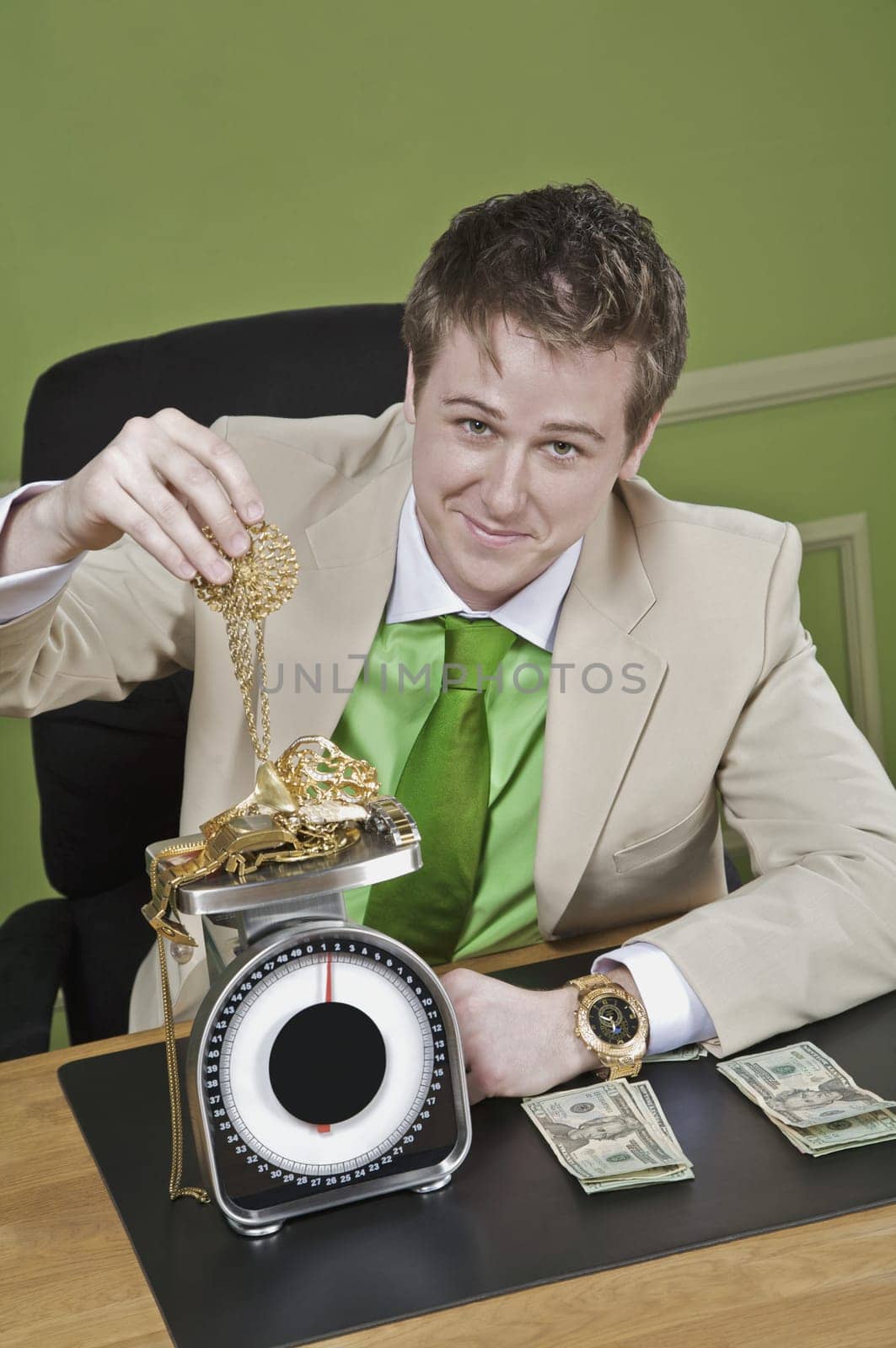 Businessman weighing gold jewelry