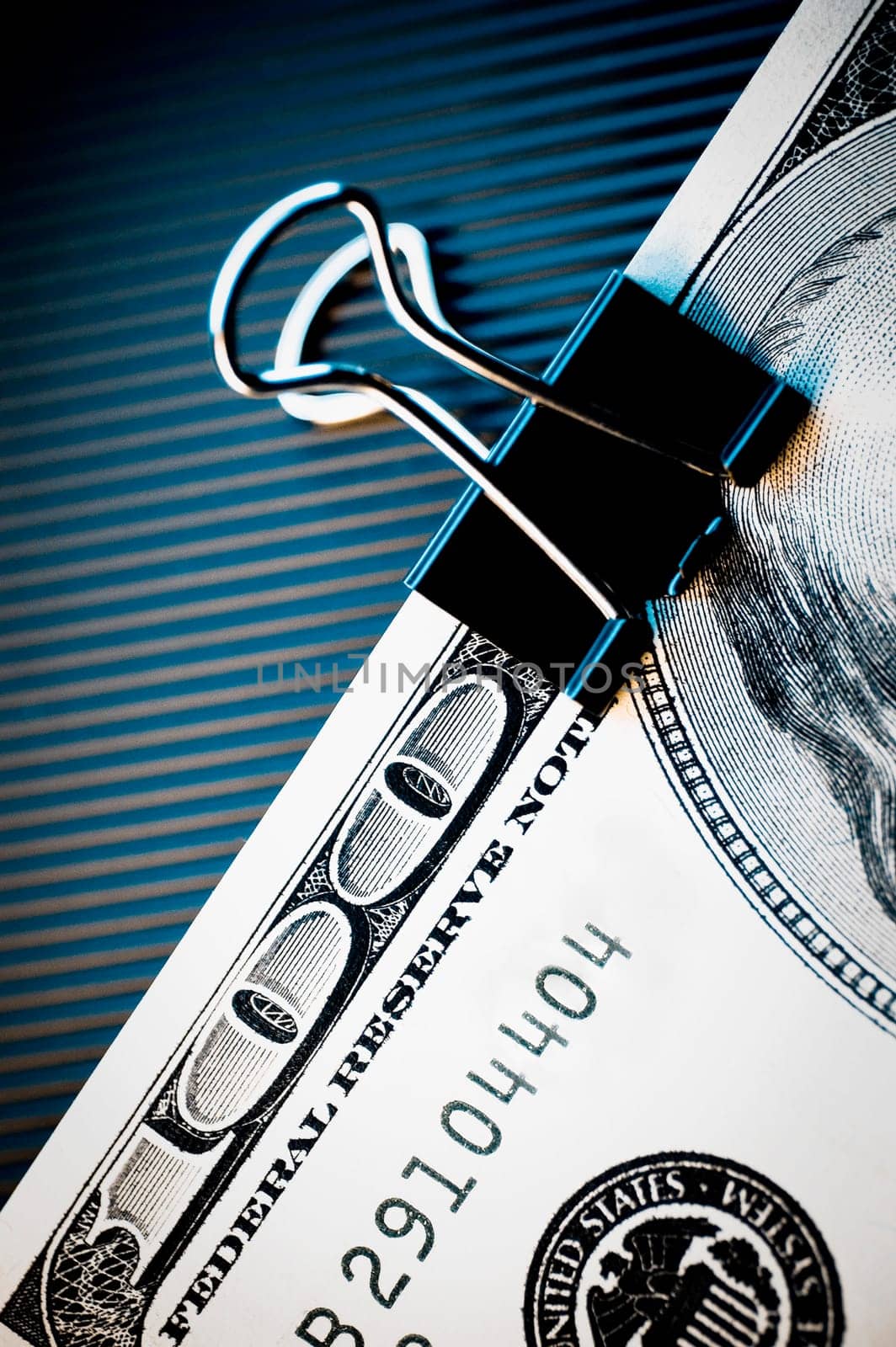 Close_up of a one hundred dollar bill in a paper clip