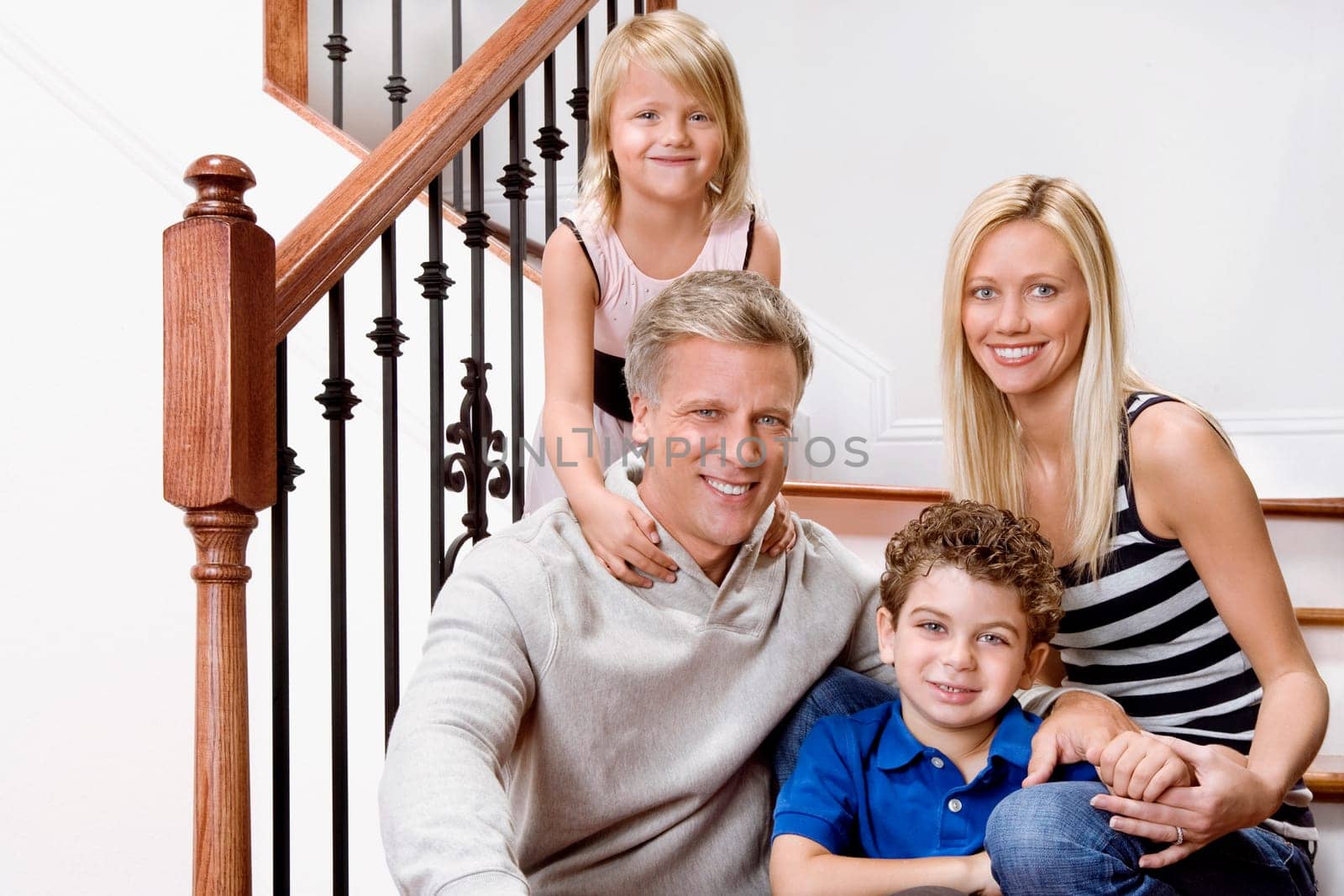 Portrait of a family smiling on a staircase